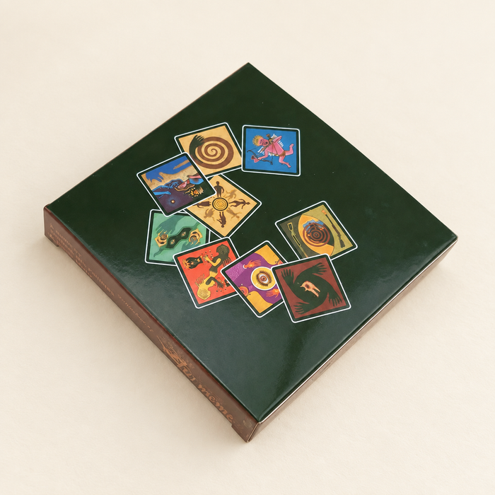 Dark green card game box on an ivory tabletop.