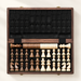 Open wooden chess and checkers case on ivory surface