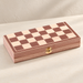 Closed wooden chess case on an ivory table
