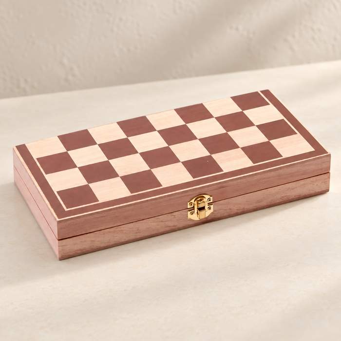 Closed wooden chess case on an ivory table