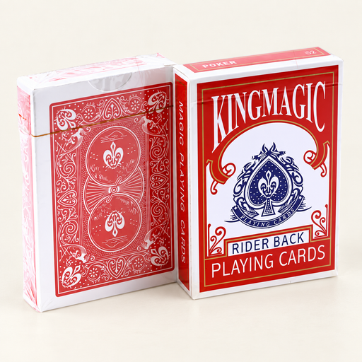 Red and white Kingmagic playing card packages on ivory table