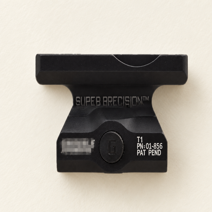 Black optic mounting bracket on an ivory surface.