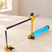 Adjustable fretsaw with silver frame, gold fittings and blue handle on an ivory worktable.
