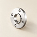 Polished stainless steel flange with four mounting holes on an ivory worktable.