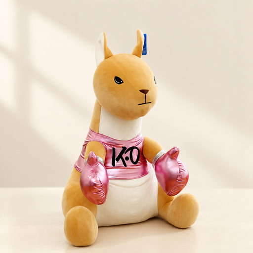 Seated kangaroo plush toy wearing pink boxing gloves and a pink shirt on a light tabletop
