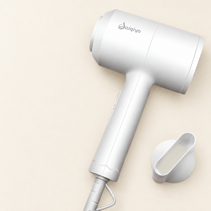 White hair dryer and detached concentrator on an ivory surface