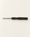 Single mini Phillips screwdriver with a black handle on an ivory work surface.