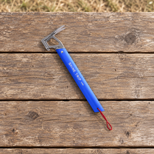 Blue camping peg hammer with silver head and red cord lying on a wooden picnic table.