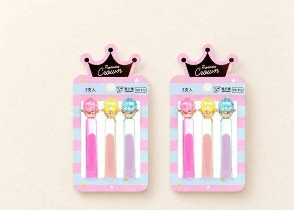 Two Crown display cards, each holding pink, yellow and blue pencil toppers.
