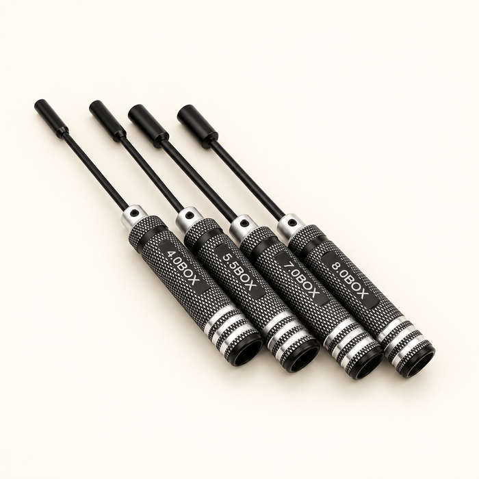 Four black RC nut drivers on ivory surface