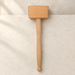 Beech wooden tenderizer on ivory stone