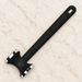 Black twin-ended tenderizer lying on ivory stone