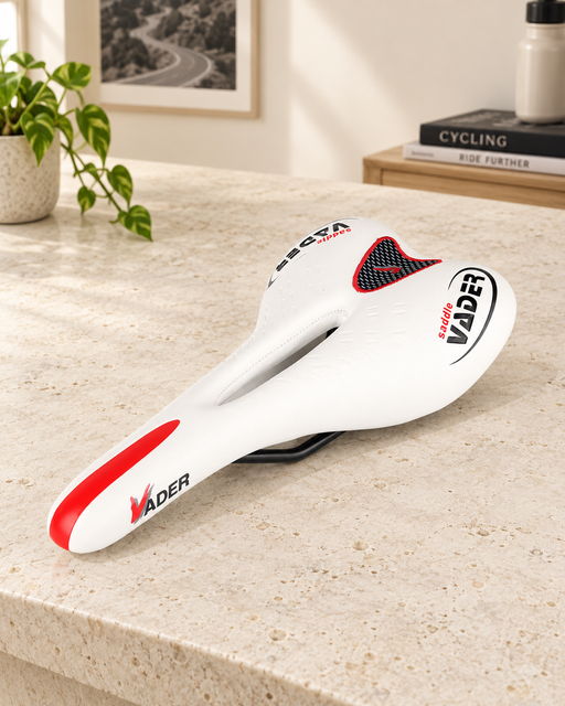 White VADER bicycle saddle with red accents on an ivory stone workbench.
