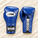 Blue boxing gloves showing front and laced back on ivory linen