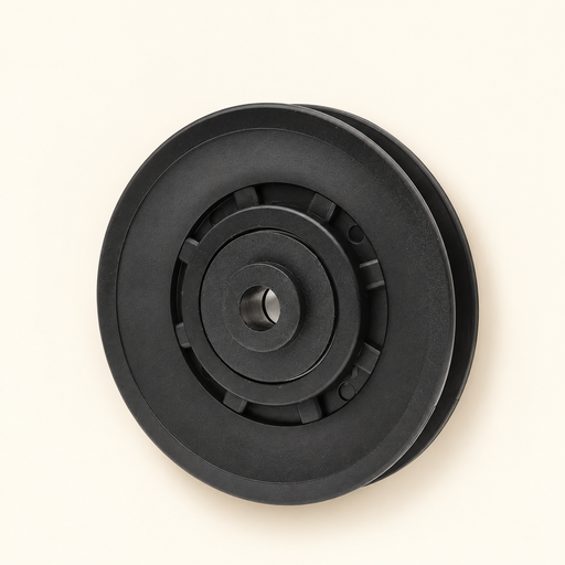 Black grooved pulley on ivory surface
