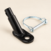 Black bicycle trailer hitch and silver safety pin on ivory surface