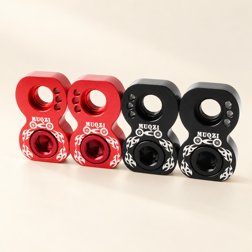 Red and black bicycle brake adapters on ivory surface