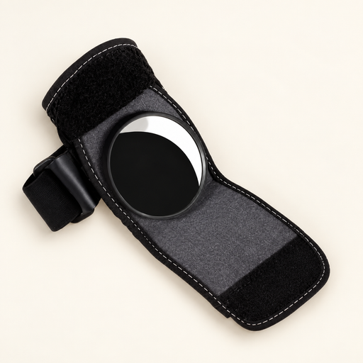 Open black wrist-mounted bicycle mirror on ivory surface