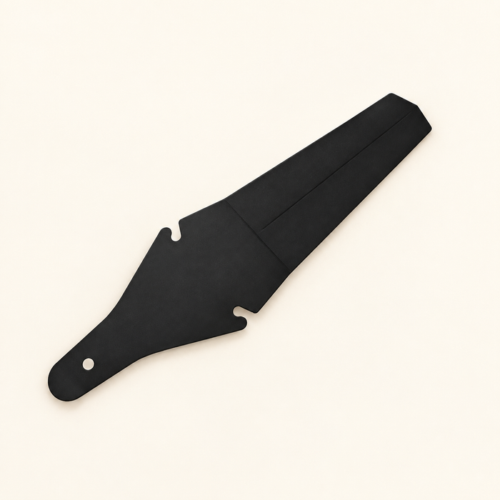 Black bicycle mudguard in flatlay on ivory surface