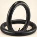 Two black bicycle inner tubes with brass valves on ivory surface