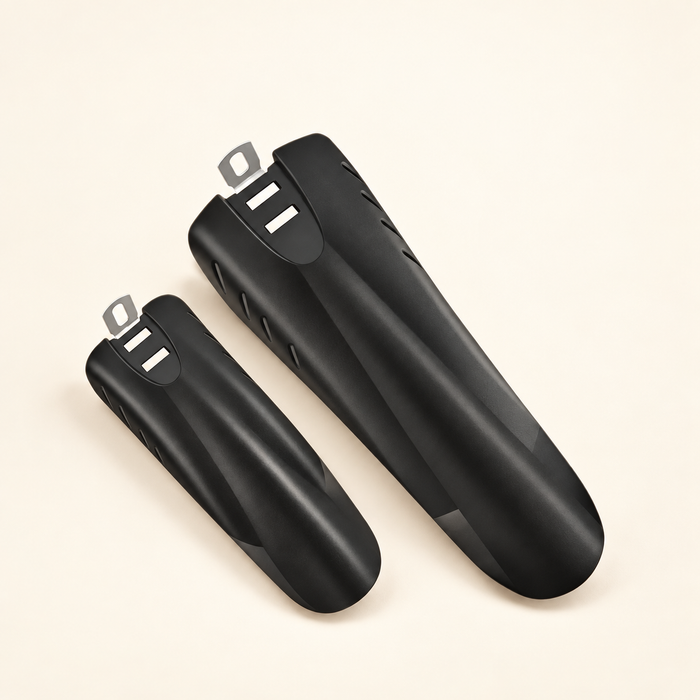 Pair of black bicycle fenders with silver mounting tabs on ivory