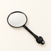 Black bicycle mirror on ivory surface