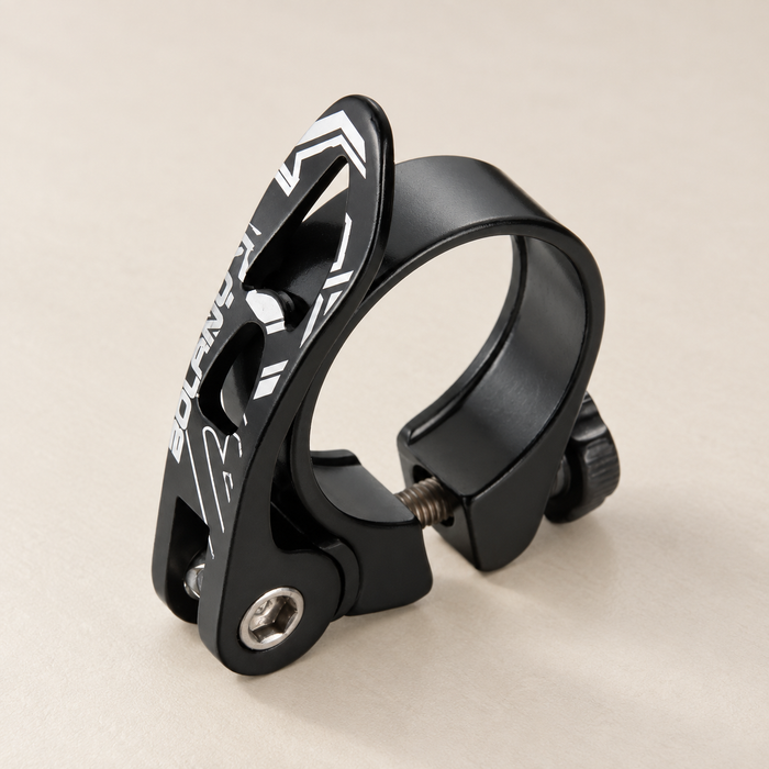 Black bicycle seatpost clamp with white graphics on an ivory tabletop