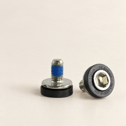 Two silver bicycle crank bolts with black caps and blue thread compound on an ivory surface.