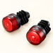 Pair of red bicycle handlebar end lights on ivory surface