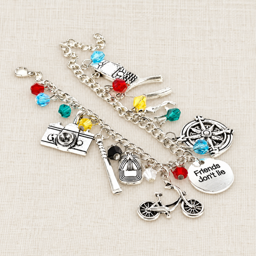 Silver charm bracelet with colourful beads on ivory linen