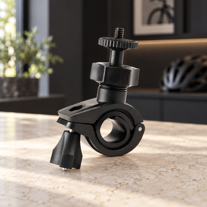 Black bicycle camera mounting clamp on an ivory stone work surface.