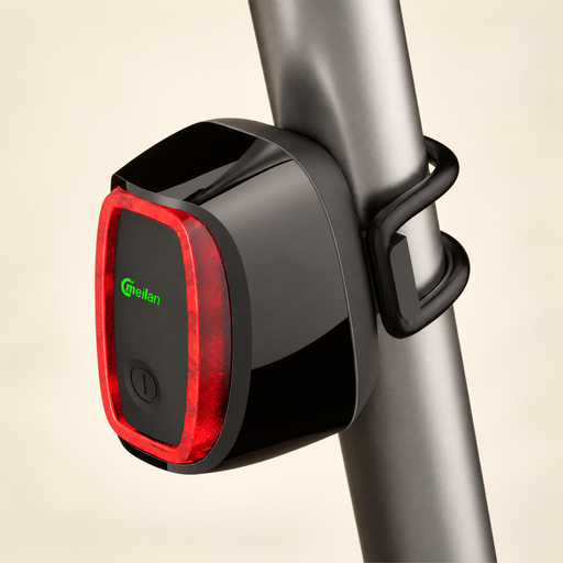 Black and red bicycle tail light mounted on grey tube against ivory