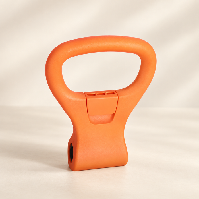 Orange dumbbell adapter handle on ivory surface