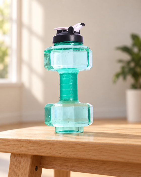 Green dumbbell-shaped water bottle with a dark lid and white flip spout on a wooden bench.
