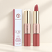 Rose-gold dual-ended lipstick tubes with original product box on ivory surface