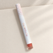 White lip colour tube with patterned cap and coral shade window
