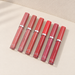 Six matte lip gloss tubes with matching caps and silver bands