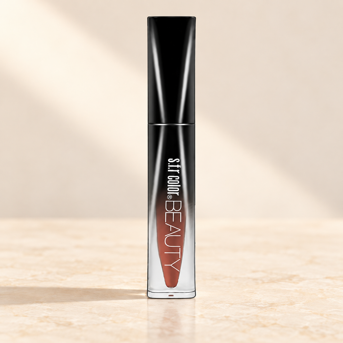 Black-capped brown-orange lip colour tube on ivory surface.