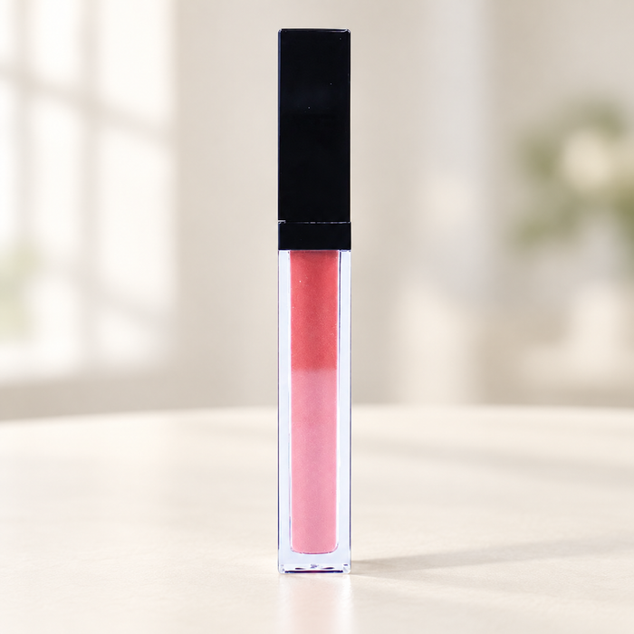 Pink lip glaze in a clear tube with black cap.