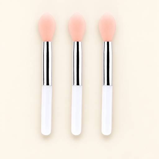 Three mini lip brushes with peach tips and white handles