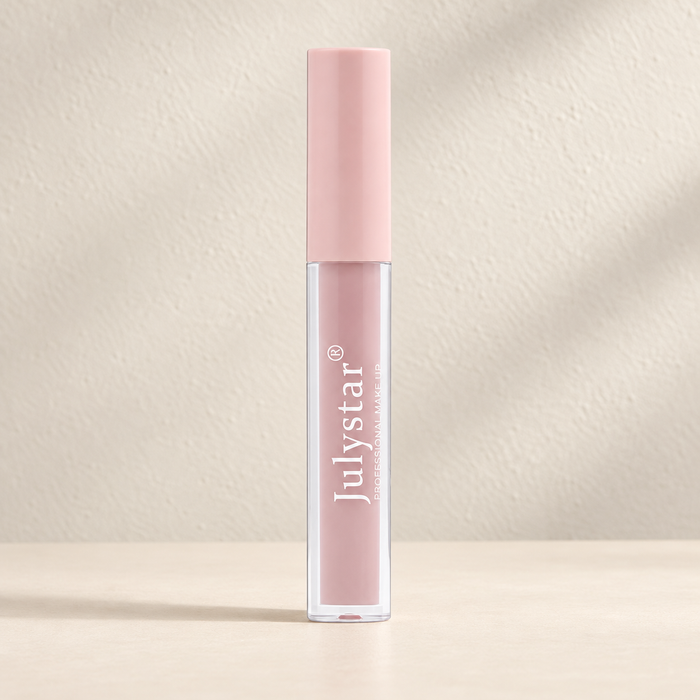 Dusty pink Julystar lip gloss with matching cap on ivory
