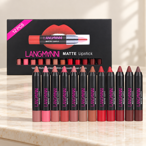 Twelve matte lipstick crayons and black presentation box on ivory surface.