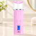 Pink and white facial mister with blue display on ivory vanity.