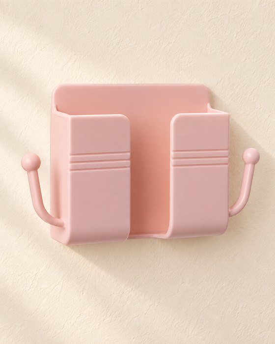 Empty blush pink wall organizer with two side hooks on an ivory wall.