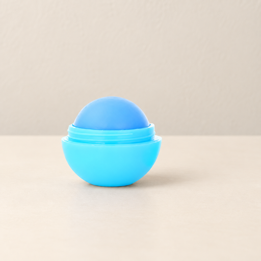 Blue round lip balm in its open cyan container on ivory