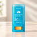 Turquoise cosmetic stick with transparent cap and orange adjustment wheel.