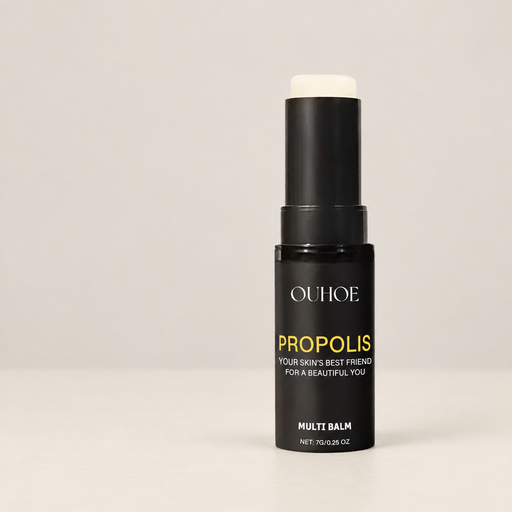 Open black moisturizing stick with a pale balm tip on an ivory surface.