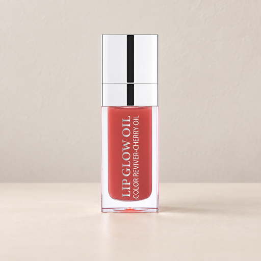 Peach pink lip oil in a clear bottle with silver cap on ivory