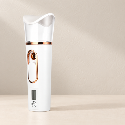White facial sprayer with rose gold trim and clear reservoir on ivory