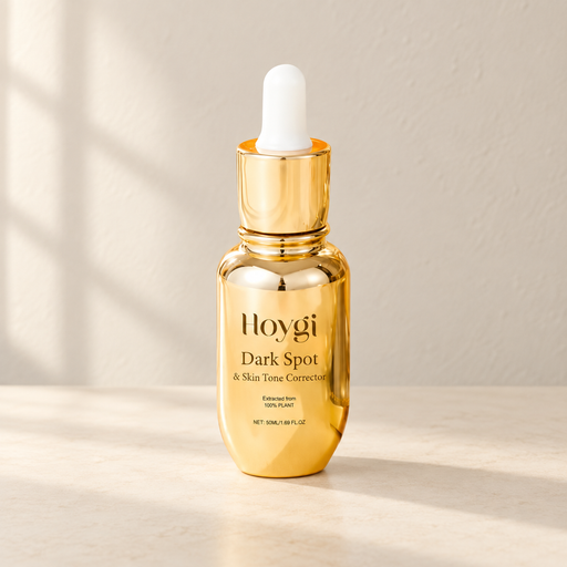 Gold dropper bottle with a white bulb on an ivory surface.
